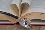Concept of cardiology with a stethoscope and a book whose pages form a heart